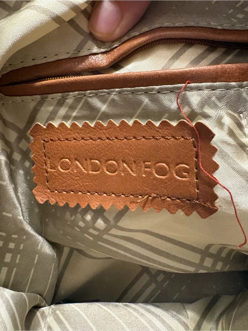 London Fog satchel features a distinctive red ostrich print and lock& key